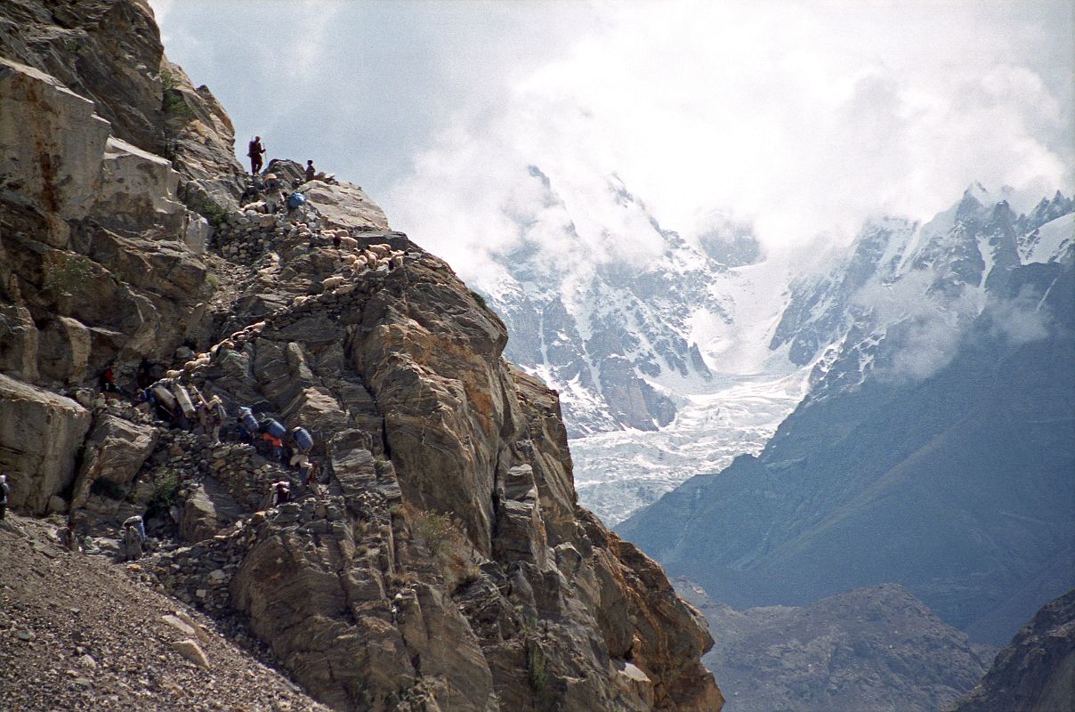 03 Climbing Zig Zag Steps Cut Out Of A Rock Blocking The Trail From Askole To Korophon With Choricho On the first day of the 135km trek to K2 Base Camp the easy trail ran out and we had to climb steep steps cut into a rock to continue the trek from Askole towards Korophon, with views ahead to the glacier below Choricho (6756m).